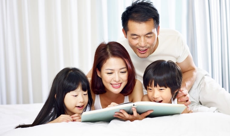 family reading a sex education book together