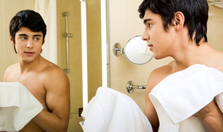 boy looking in a mirror for a teachable moment