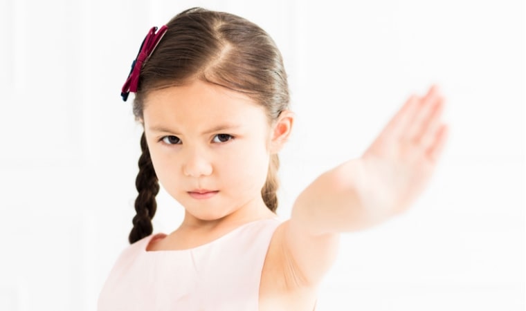child holding arm out to say stop, after reading books about consent