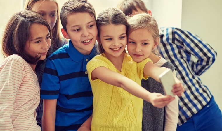 group of children taking a selfie for social media safety
