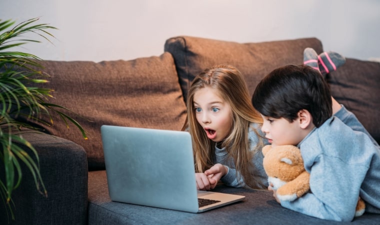 shocked children looking at a computer, after reading books aobut pornography