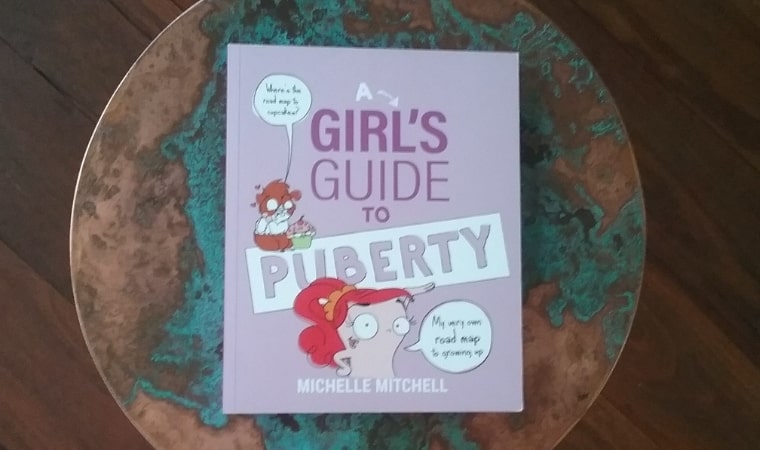 cover of a girls guide to puberty by michelle mitchell