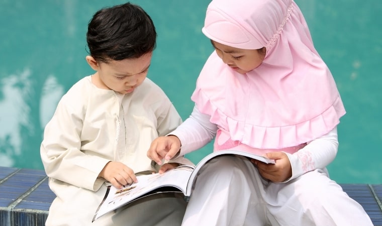 2 muslim children readign a sex education book