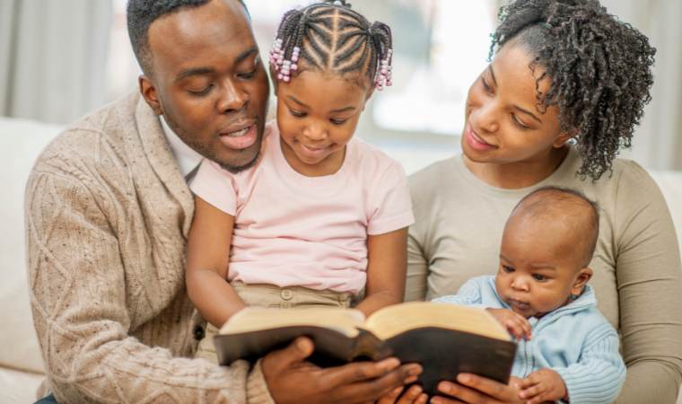 christian family looking at a bible and talking about sex education