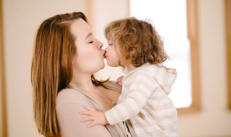 Affectionate parent-child lip kiss