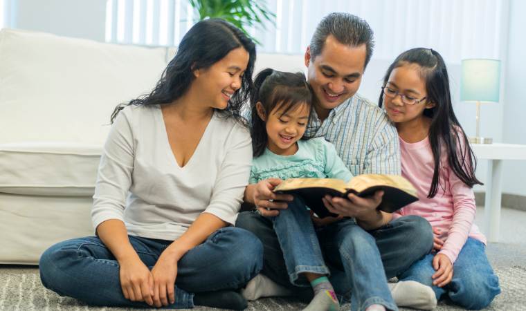 family reading the bible and a sex education book