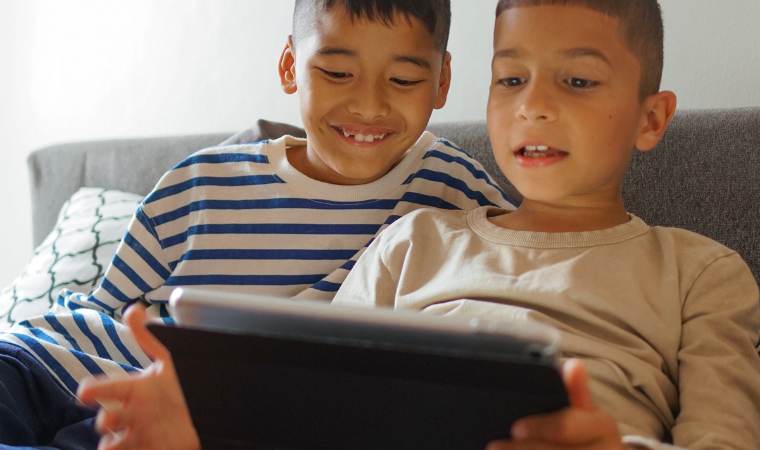 two young boys playing on the internet safely as they have been taught cybersafety
