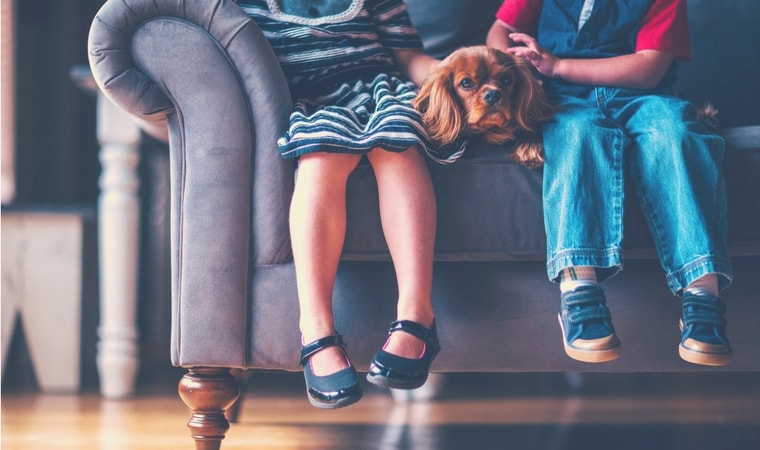 children sitting on lounge with a dog puberty for kids