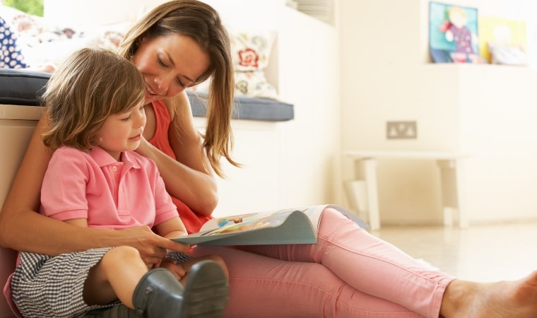 mother reading sex education books for 5 year olds child