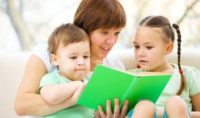 mother reading sex education books for 6 year olds child